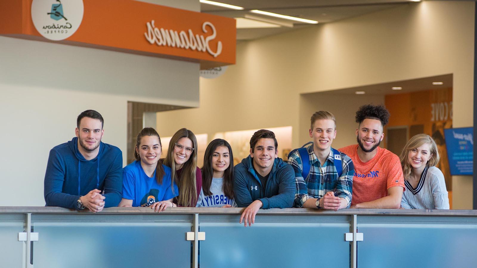 Group of University of Mary students overlooking the balcony in the Lumen Vitae University Center.